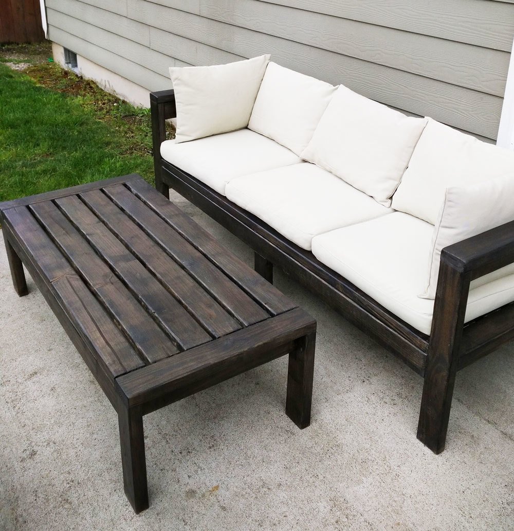 outdoor sofa stained chocolate brown with white cushions and matching coffee table