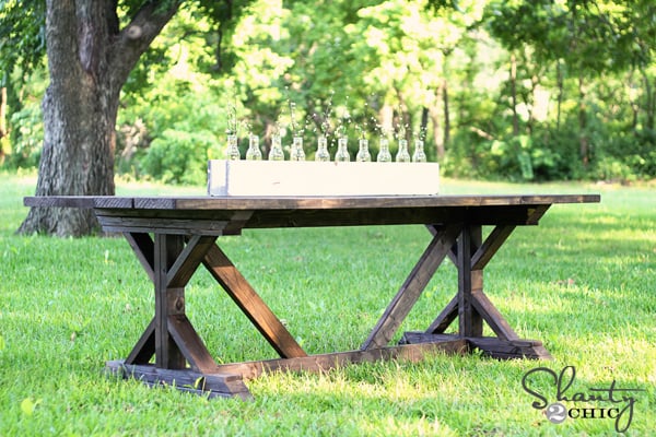 dark wood stained farmhouse table with X legs and cross bracing