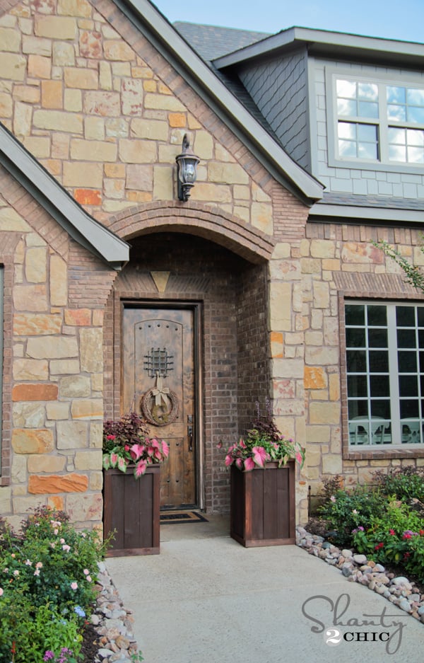 cedar planters on either side of the front door