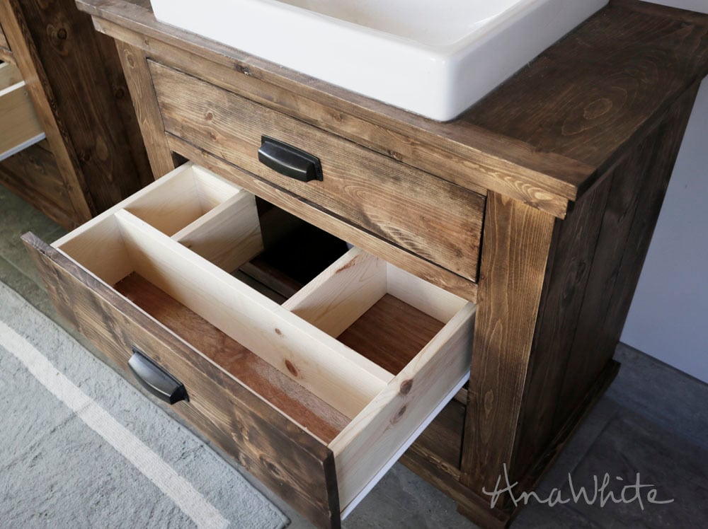 bathroom vanity with drawer open showing custom drawer fit around the plumbing