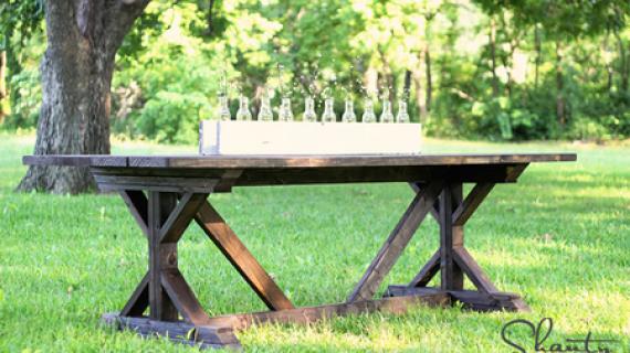 dark wood stained farmhouse table with X legs and cross bracing