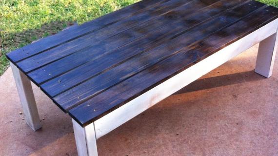 outdoor coffee table with wood stained top and white distressed base
